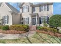 Inviting home exterior with brick steps, professional landscaping, and a covered front entry creating an attractive approach at 10615 Persimmon Creek Dr, Mint Hill, NC 28227