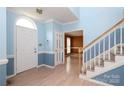 Sunlit foyer with hardwood floors, classic trim, and a glimpse into adjacent living spaces at 10914 Ridge Acres Rd, Charlotte, NC 28214