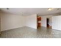 Spacious living area with tile flooring leading to kitchen with wood cabinets at 110 Balsam Dr, Lincolnton, NC 28092