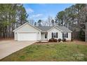 Lovely one-story home with well-kept lawn, gray siding, and attached two-car garage at 113 Misty Spring Rd, Troutman, NC 28166