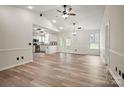 Bright, open-concept living area featuring hardwood floors and a seamless flow into the modern kitchen at 113 Misty Spring Rd, Troutman, NC 28166