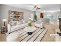 Bright, staged living room featuring a comfortable sofa, stylish decor and open concept at 114 Sheridan Ct, Mooresville, NC 28115