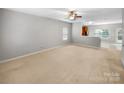Spacious living room with neutral carpet, large windows, and ample natural light. Ready for your personal touch at 114 Sheridan Ct, Mooresville, NC 28115