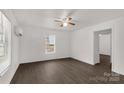 Bright living room featuring sleek flooring, a ceiling fan, and ample natural light at 1141 6Th St, Lancaster, SC 29720