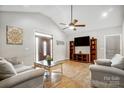 Bright living room features vaulted ceiling, hardwood floors, and large windows that let in lots of natural light at 125 Jefferson Dr, Locust, NC 28097