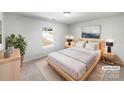 Cozy bedroom with a large window, a comfortable bed, and neutral decor in a staged home at 1311 Shady Oak Trl, Gastonia, NC 28052