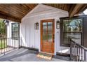 Attractive wood front door with glass inset, enhanced by decorative lighting and a cozy welcome mat at 1331 14Th Ne St, Hickory, NC 28601