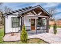 Attractive white exterior with black trim, covered porch, and tastefully landscaped front yard at 1331 14Th Ne St, Hickory, NC 28601