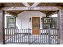 Charming covered front porch with rustic wood beams and black railing, perfect for relaxing outdoors at 1331 14Th Ne St, Hickory, NC 28601