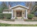 Inviting front porch with charming columns, double doors, and beautiful planters creates a welcoming entrance at 1409 Cortland W Rd, Charlotte, NC 28209