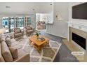 Bright living room featuring neutral tones, a cozy fireplace and views of the dining area at 1419 Deer Forest Dr, Fort Mill, SC 29707