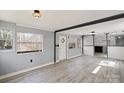 Bright living room with ample natural light and modern floors flowing into the kitchen at 144 Cherokee Ln, New London, NC 28127