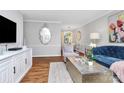 Elegant living room featuring hardwood floors, stylish furnishings, and abundant natural light and open floor plan at 1817 Jameston Dr, Charlotte, NC 28209