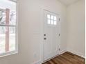 Bright entryway featuring a white door with glass panes and warm-toned wood floors at 2313 N Main St, Kannapolis, NC 28081