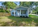 Charming blue home with a welcoming front porch and black shutters at 2313 N Main St, Kannapolis, NC 28081
