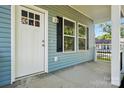 Inviting front porch with white columns and black railing accents at 2313 N Main St, Kannapolis, NC 28081
