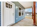 Inviting covered front porch with blue siding and natural wood posts, a perfect spot for relaxing outdoors at 2313 N Main St, Kannapolis, NC 28081
