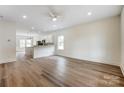 Open-concept living area with wood floors, seamlessly connecting to the kitchen and dining space at 2313 N Main St, Kannapolis, NC 28081