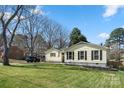 Inviting one-story home with a well-kept lawn, mature trees, and classic black shutters at 2413 Hoffman St, Gastonia, NC 28054