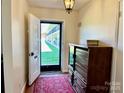 View of the entryway with hardwood floors and a decorative rug at 3010 Crosby Rd # 122, Charlotte, NC 28211