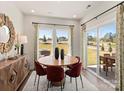 Bright dining area with a round wood table, red chairs, and sliding glass doors to the backyard at 307 Alden Ct, Shelby, NC 28152