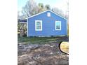 Side view of cozy single-story home with blue siding and white trim, showcasing its simple design at 336 Hudson St, Shelby, NC 28150