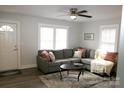 Bright living room featuring a comfortable gray sectional sofa and a ceiling fan at 407 E Talleyrand St, Monroe, NC 28112