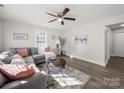 Cozy living room featuring a large sectional, ceiling fan, and ample natural light at 407 E Talleyrand St, Monroe, NC 28112