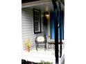 Cozy front porch featuring a chair, table and a blue door at 407 E Talleyrand St, Monroe, NC 28112