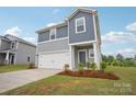Beautiful two-story home with a two-car garage, well-maintained lawn, and attractive landscaping at 410 Luna Ln, Shelby, NC 28152