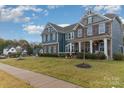 Two story home with a well-manicured lawn, showcasing a charming curb appeal and inviting entrance at 4660 Ardmore Ln, Harrisburg, NC 28075