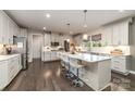 Modern kitchen with a center island, stainless steel appliances, and ample cabinet space, perfect for cooking and entertaining at 4660 Ardmore Ln, Harrisburg, NC 28075