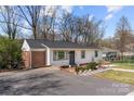 Beautifully renovated home featuring a classic design, new driveway, and appealing landscaping at 4820 Valley Stream Rd, Charlotte, NC 28209