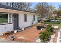 Charming entrance with brick patio, seating, and beautiful landscaping for outdoor enjoyment at 4820 Valley Stream Rd, Charlotte, NC 28209