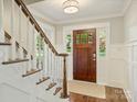 Charming entryway featuring a wooden door with decorative glass and traditional finishes at 4830 Broad Hollow Dr, Charlotte, NC 28226