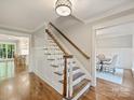 Elegant staircase with wood treads, white risers and banisters, leading to the upper level at 4830 Broad Hollow Dr, Charlotte, NC 28226