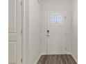 Bright entryway features a secure front door, wood-look flooring, and white trim at 511 Roberts St, Shelby, NC 28150