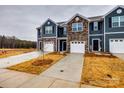 Exterior view of townhouses with stone and siding, individual driveways, and landscaping, showcasing a well-maintained community at 522 Trading Post Ln, York, SC 29745