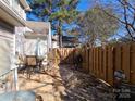 Fenced backyard area with patio furniture and a grill, perfect for outdoor enjoyment at 5963 Moose Ln, Charlotte, NC 28269