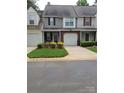 Well-kept townhome with landscaped front yard, garage, and covered entry at 5963 Moose Ln, Charlotte, NC 28269