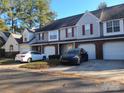 Townhome exterior showing siding, brick accents, garages, and driveway parking for multiple vehicles at 5963 Moose Ln, Charlotte, NC 28269
