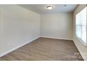 Bright bedroom features wood-look flooring and natural light from the large window at 600 Hunley St, Monroe, NC 28112