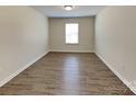 Comfortable bedroom featuring wood-look flooring and a bright window at 600 Hunley St, Monroe, NC 28112