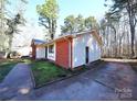 Side view of a home featuring brick accents and a concrete driveway at 6245 Snowcrest Ct, Charlotte, NC 28212