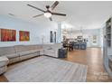 Open-concept living room flows into a modern kitchen, featuring a large ceiling fan and lots of light at 629 Gants Rd, York, SC 29745