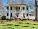 Charming two-story home with a covered front porch, white pillars and a well-manicured lawn at 638 Forest Ln, Rock Hill, SC 29730