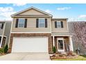Charming two-story home with a welcoming front yard, brick accents and a two car garage at 638 Nannyberry Ln, Concord, NC 28025