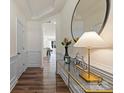 Bright hallway featuring hardwood floors, elegant wall trim and decor at 6450 Keeton Ln, Harrisburg, NC 28075