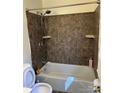 Standard bathroom with a tiled shower and white fixtures at 6520 Farmway Pl, Charlotte, NC 28215