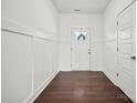 Bright entryway with wood floors, decorative trim, and a charming front door at 719 S Franklin St # 2, China Grove, NC 28023